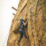 boy climbing a rock wall